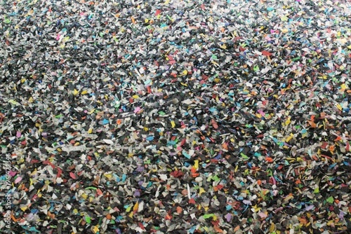 Konstfotografi A large pile of multicolored shredded plastic fragments for industrial recycling processes