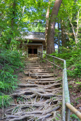 Steps leading to Kyozo Sutra Repository located at Chuson-ji Temple in Hiraizumi Iwate Japan surrounded by nature