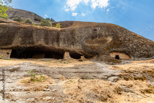 View of rock-cut entrances in the Hermit Caves used by monks for seclusion and meditation in Meteora, Thessaly, Greece