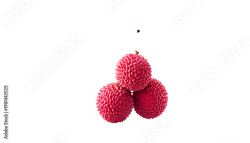Three ripe, textured red lychee fruit are stacked against a black background