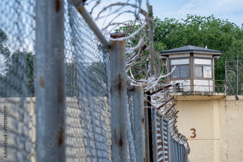 Konstfotografi Prison guard tower with razor wire fence.