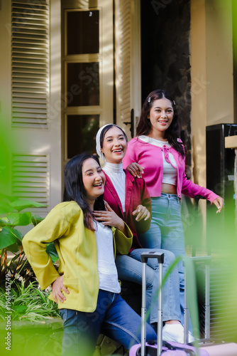 Three vibrant friends, brimming with youthful energy, joyfully anticipate their trip, showcasing a playful camaraderie and the excitement of a shared travel experience with luggage.