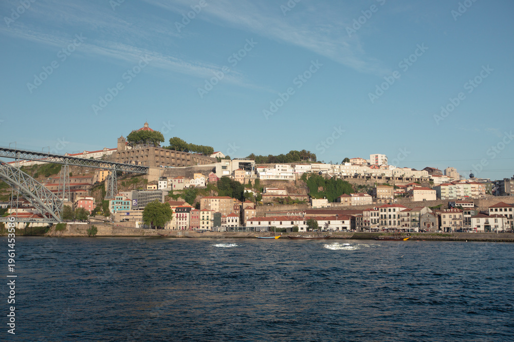 Fototapeta premium The river in Porto, Portugal, a view from above of the city and the river with passing ships at dawn