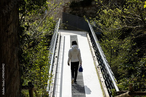 Narni Umbria Italy Woman Walking Modern Metal Pedestrian Bridge Scenic Nature Landscape Travel Destination Chronicles Narnia CS Lewis Fantasy Book Inspiration Outdoor Active Lifestyle Sunny Day Hiking