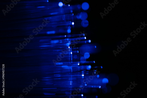 Blue fibers glow softly against deep black