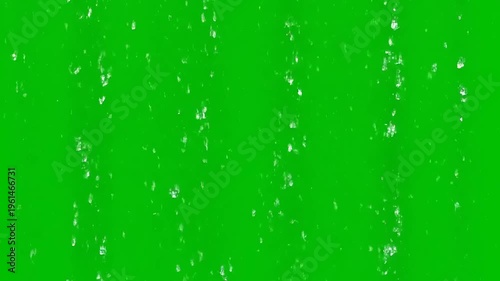 Falling water droplets on a vibrant green screen background, ideal for visual effects and motion graphics projects