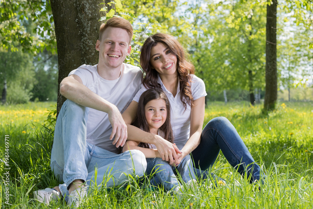 Fototapeta premium A very happy family on the green grass