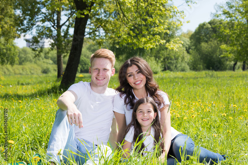 A very happy family on the green grass