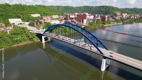 WEST VIRGINIA - 6.24.2024 - Very good aerial footage panning traffic driving across bridges on the Monongahela River in West Virginia.