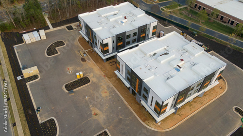 Aerial drone inspection of commercial TPO roof featuring heat-welded seams, HVAC curb flashing, and pipe penetrations.