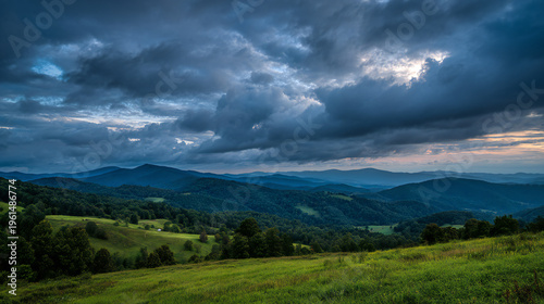 Rolling green hills with blue hour light and dramatic clouds, landscape photography