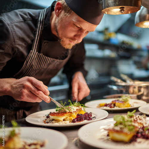 Chef plating gourmet dish with precision in professional kitchen, culinary action shot