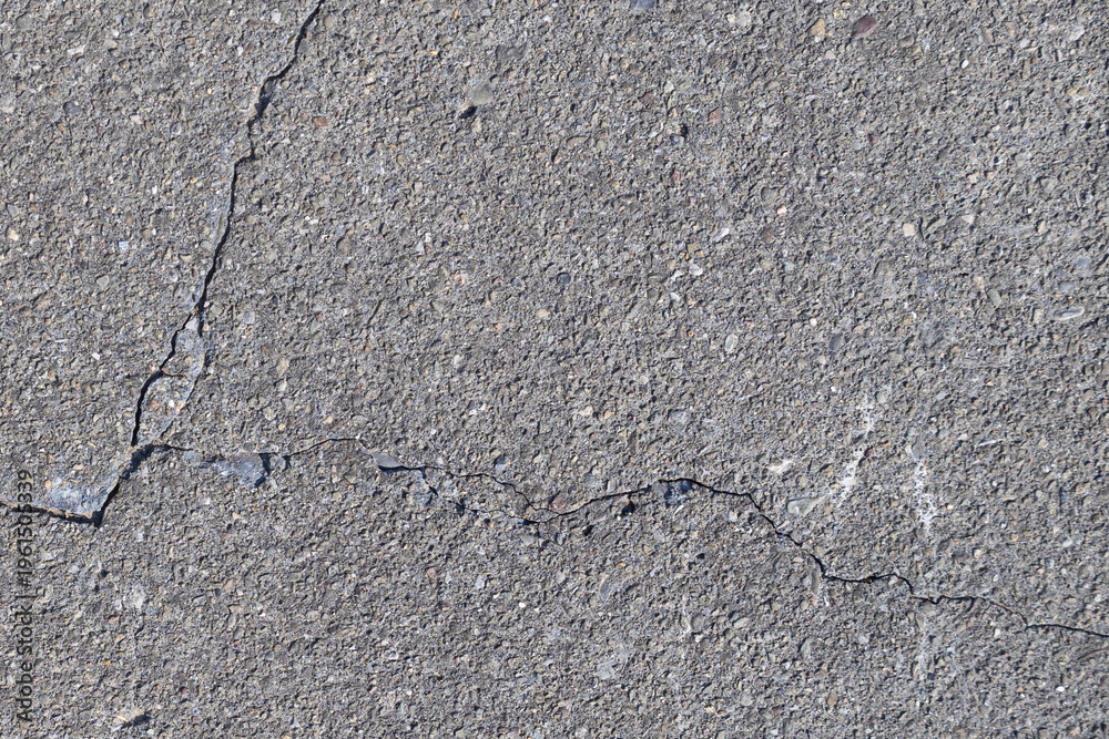 Obraz premium Cracked Concrete Surface Texture with Diagonal Fracture Line Background