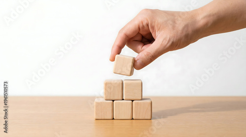 Wallpaper Mural Hand stacking wooden blocks to build pyramid, concept of growth and development Torontodigital.ca