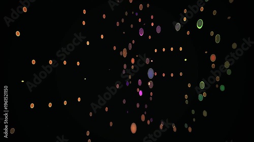 Colorful particles floating in darkness.