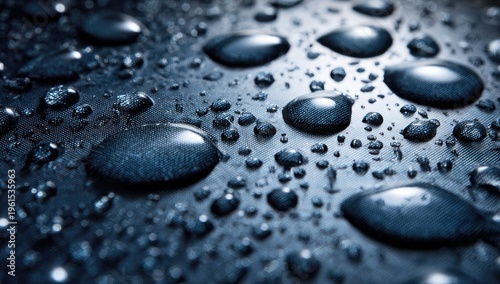 Close up of dark surface covered with many glistening water droplets