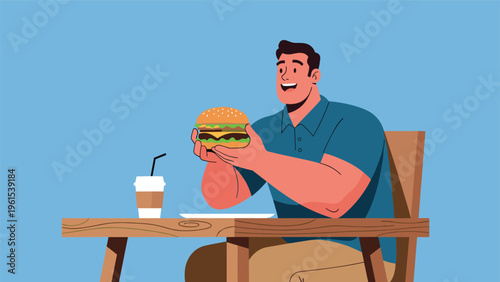 Happy man sitting at a table and holding a large juicy hamburger with a drink on the side in a blue background.