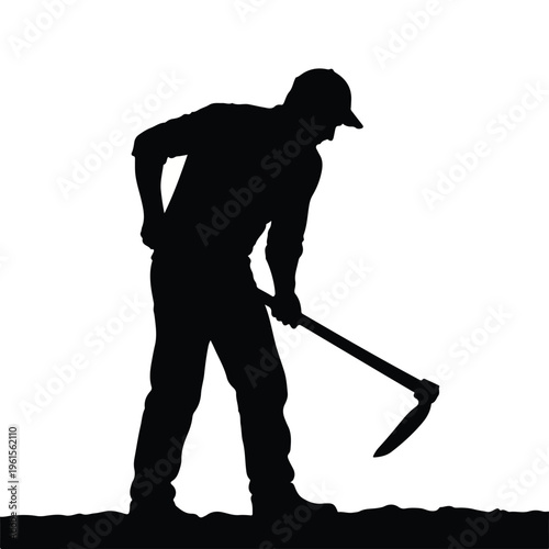 Silhouette of a Farmer Digging Soil with a Hoe
