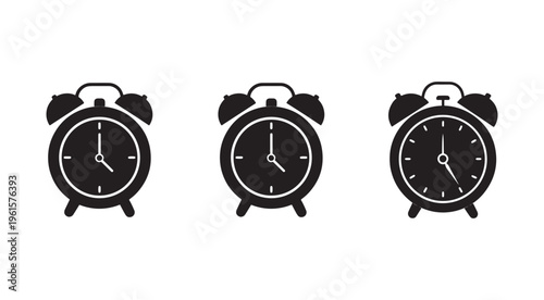 Three black and white alarm clocks with different times on white background