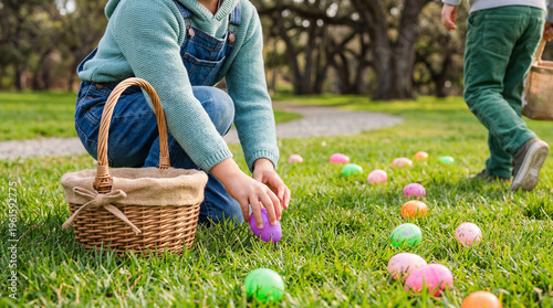 Young child joyfully collecting colorful plastic Easter eggs into a rustic basket on a bright, sunny spring day.