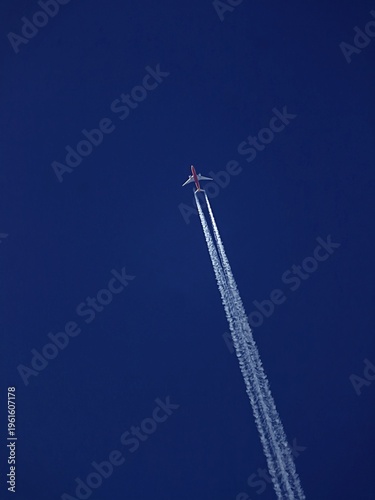 Aircraft at high speed leaving contrails behind.