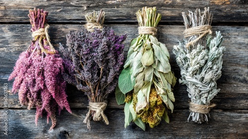 Bundles of various dried botanicals are secured with twine against a weathered wooden surface.