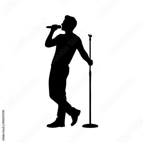 Silhouette of a Male Singer Performing on Stage with Microphone.