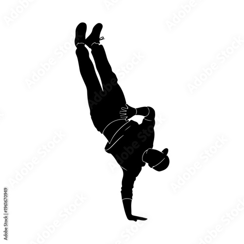 Silhouette of a B-boy performing a handstand breakdance move.