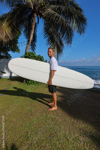 Approachable Beach Coach In Casual Attire Preparing To Instruct Newcomers On Surfing Techniques