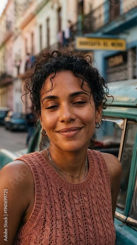 Smiling Woman with Dark Curly Hair Near Green Vehicle