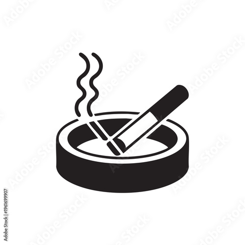 A burning cigarette rests in an ashtray emitting smoke.