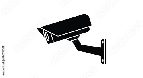 Black security camera on a white wall a stark silhouette