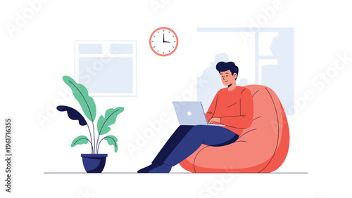 Productive man works remotely on his laptop while relaxing in a comfortable red beanbag chair in a bright modern office.