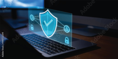 Digital security shield hologram glowing on laptop screen, symbolizing cybersecurity, data protection, and online privacy