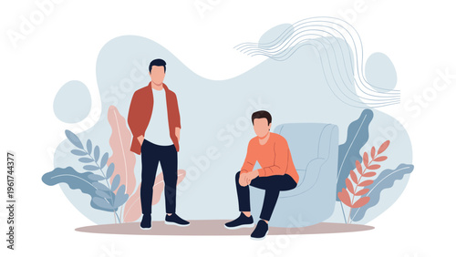 Two modern men pose together in a stylish setting with one standing and the other sitting in an armchair against an abstract background.