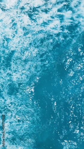 Powerful tropical turquoise waves with white foam, aerial top view, coral barrier reef