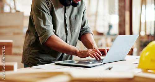 Carpentry, typing or hands with laptop in workshop, creative project or digital planning for craft. Research, furniture inspiration or man with tech for woodworking, check deadline or production info
