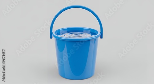 A bright blue bucket filled with clear water and ripples on its surface