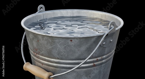 Old metal bucket filled with clear water, isolated on black background
