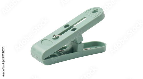 Close-up photograph of a single light green plastic clothespin, useful for laundry and household tasks.