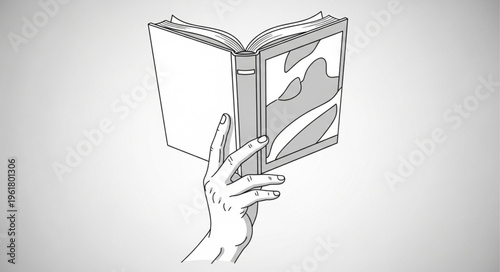Hand holding an open book with an illustration, ready to read.