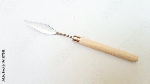 Stainless Steel Palette Knife with Wooden Handle rotating on White Background, Artist Painting Tool for Acrylic and Oil Painting