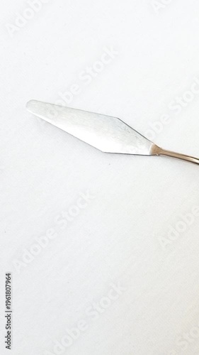 Stainless Steel Palette Knife with Wooden Handle rotating on White Background, Artist Painting Tool for Acrylic and Oil Painting, vertical clip