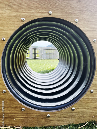 Playground Tunnel View with Circular Pattern and Outdoor Background