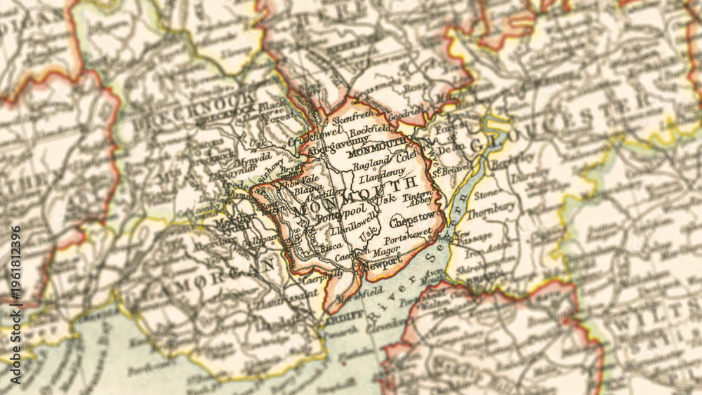 Obraz premium Macro View of Vintage Map Highlighting Monmouthshire Wales with Detailed Regional Cartography