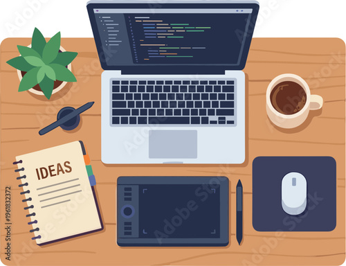 A cluttered desk with a laptop displaying code, a notebook, and a graphics tablet.