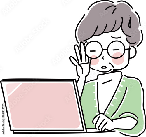 ノートパソコンの操作をする老眼のシニア女性
