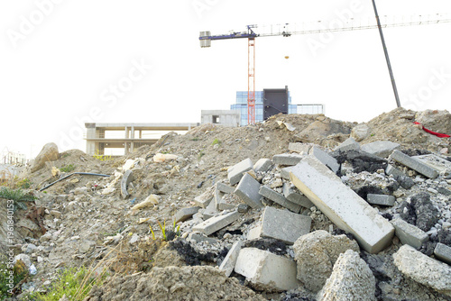 Cuadro en lienzo Pile of broken concrete blocks and construction debris with crane in distance