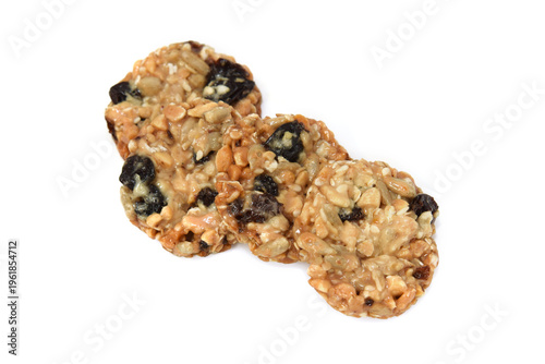 Sunflower seeds, oats cereals, raisins in caramel. Whole cookies closed up isolated on white.