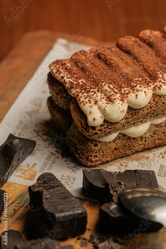 Fényképezés Macro shot of a decadent tiramisu dessert with dark chocolate pieces